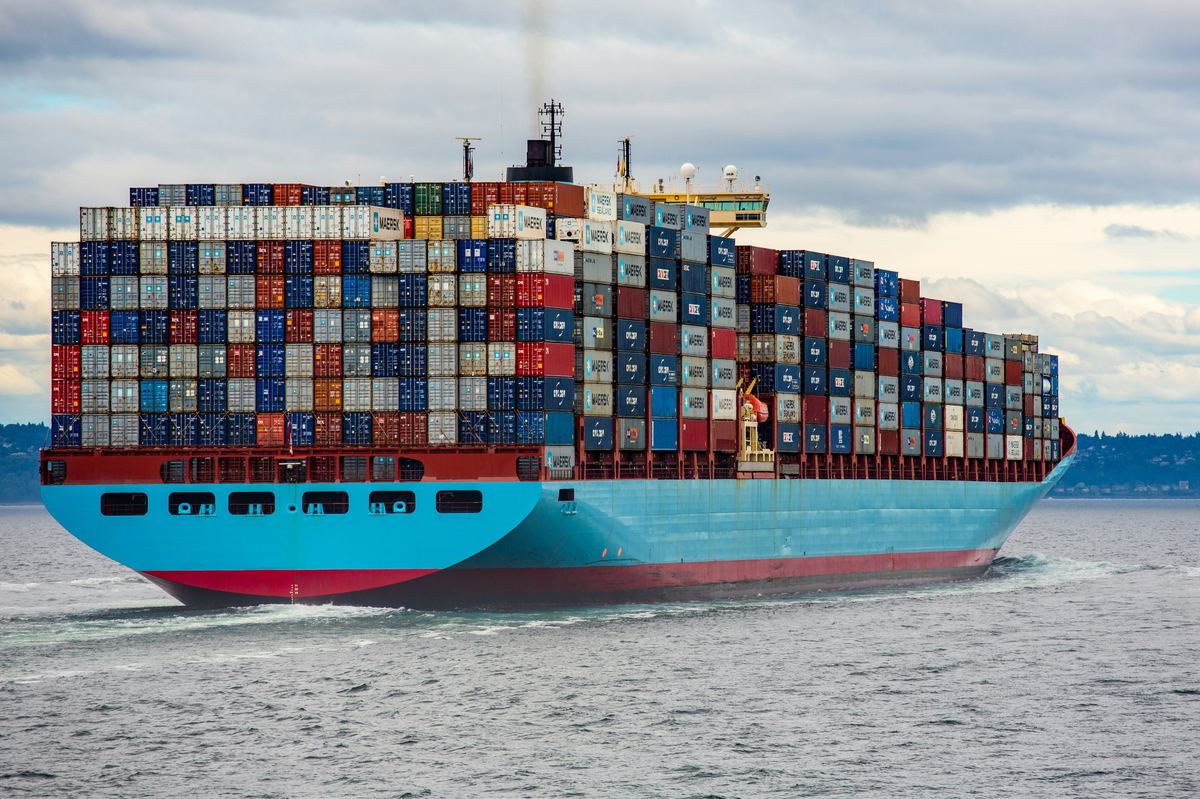 Cargo plane and container ship representing air vs sea freight options